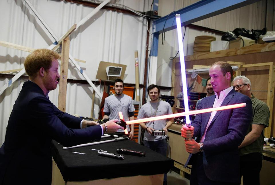 The princes play with lightsabers on set