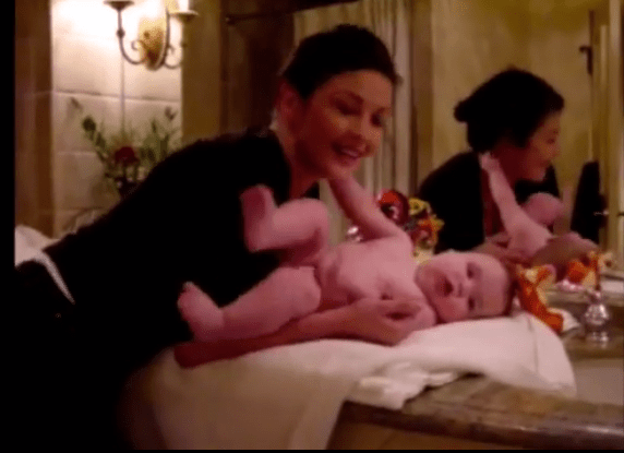  Catherine Zeta-Jones changes her son's nappy in one sweet moment from the video