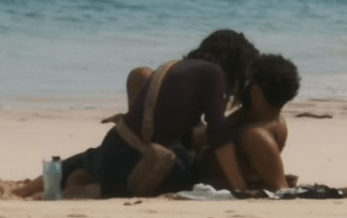  The pair enjoyed a kiss as they sat on the sand