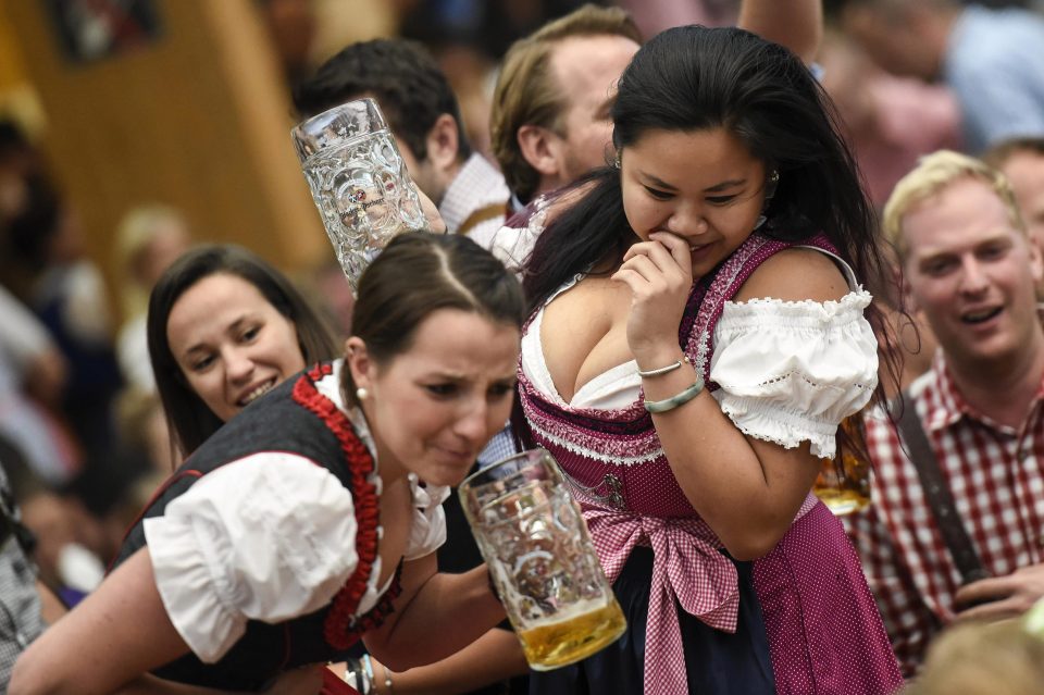  Two women engage in a beer drinking contest in the Hacker Pschorr tent