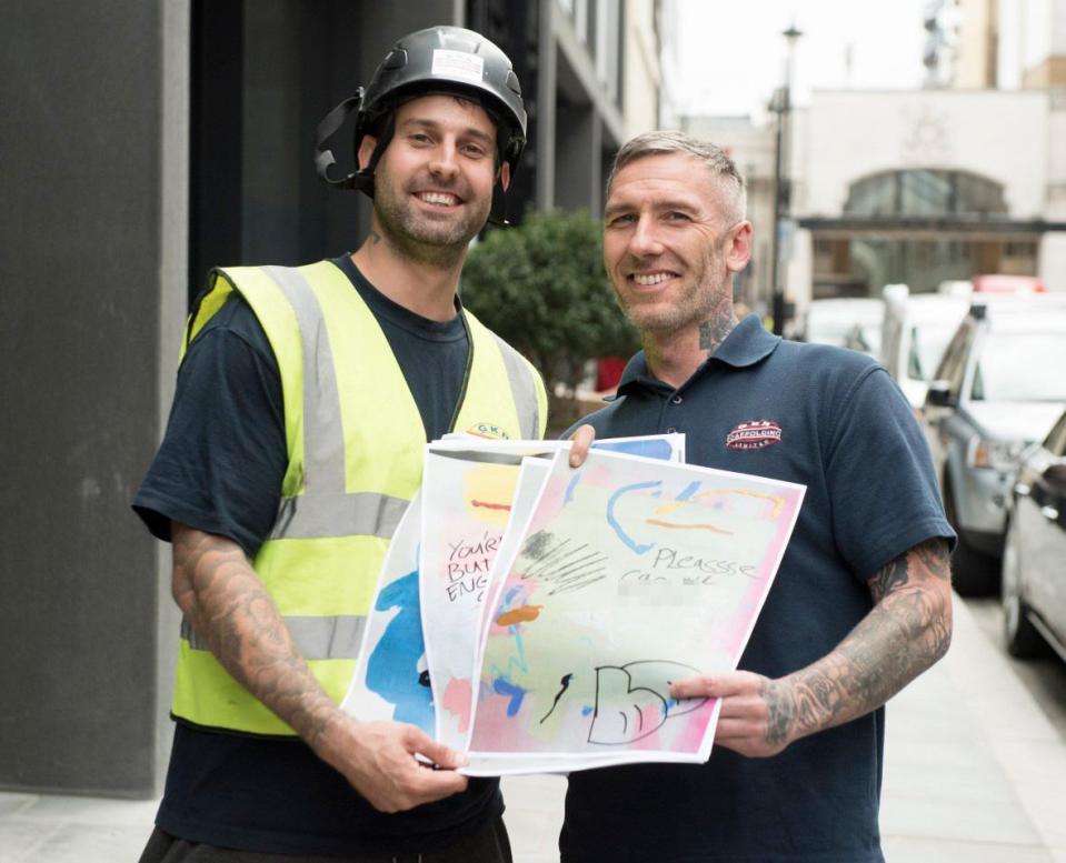  The two tradesmen pose for the camera holding Hetty's work which Warren, left, blasted as 'crude and ignorant'