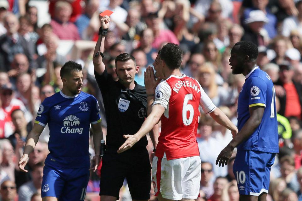 Oliver gets out his red for Laurent Koscielny the final day of last season