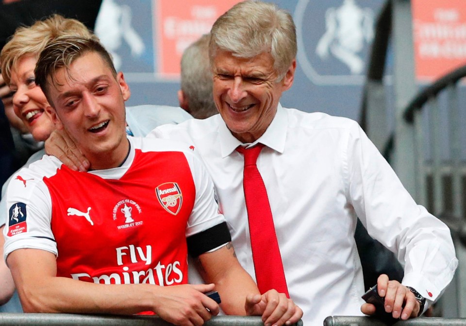 Ozil and Wenger share a joke after beating Chelsea in the FA Cup final last season