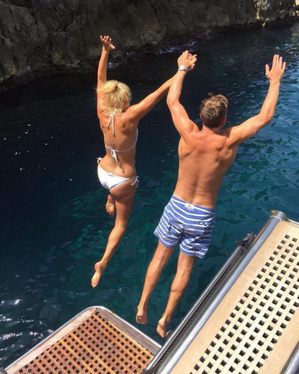  Holly shared a snap showing her jumping off a yacht with Dan