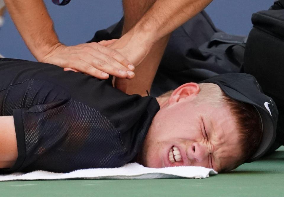  Kyle Edmund receives treatment on the ground on his injured neck