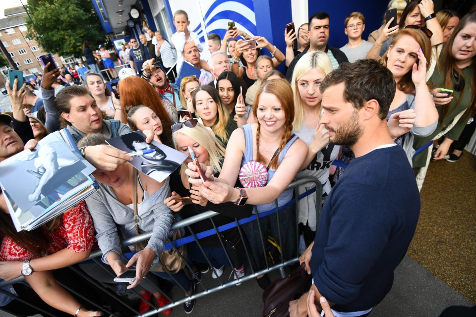 Jamie Dornan poses with fans before the Grenfall charity match