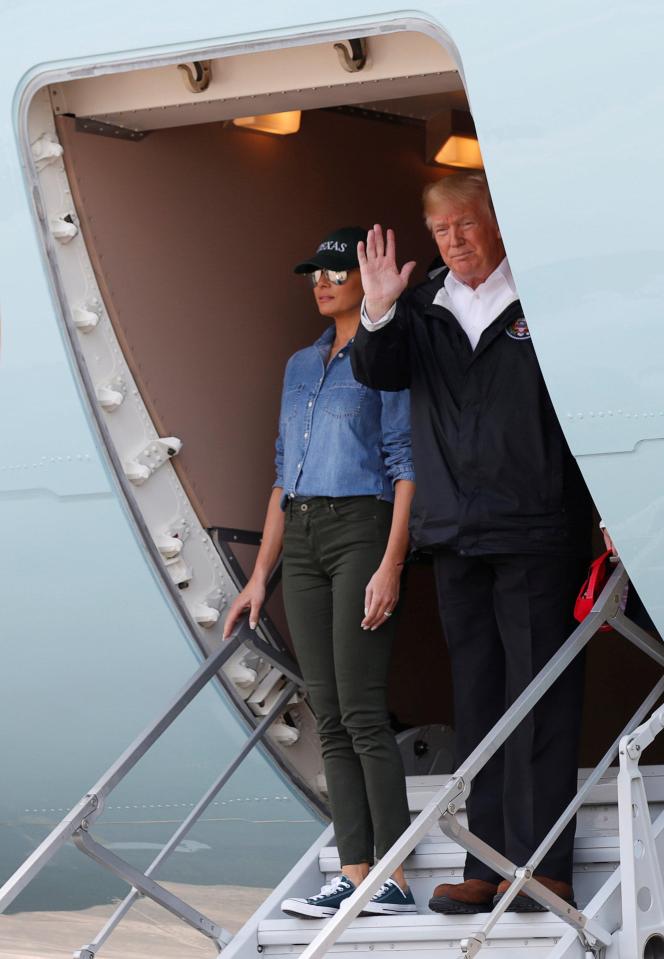 U.S. President Donald Trump and first lady Melania Trump wave from Air Force One after arriving at Ellington Field to meet with flood survivors and volunteers who assisted in relief efforts in the aftermath of Hurricane Harvey, in Houston, Texas