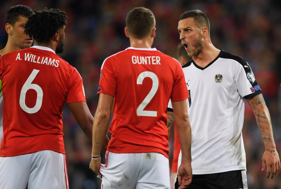  Austria forward Marko Arnautovic clashes with Ashley Williams and Chris Gunter