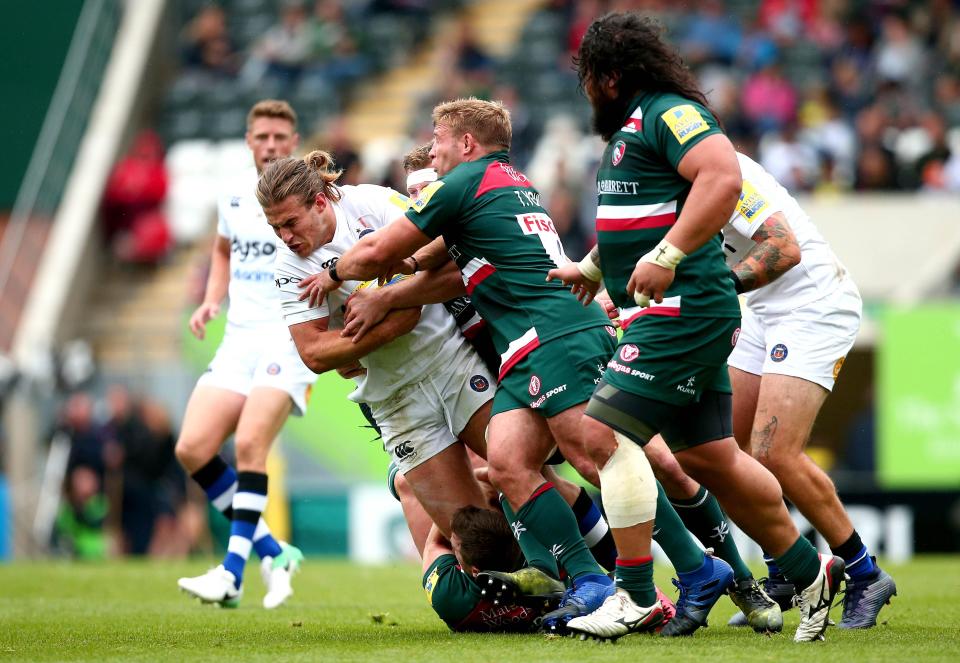  Max Clark holds on to the ball as Leicester attempt to bring him down at Welford Road