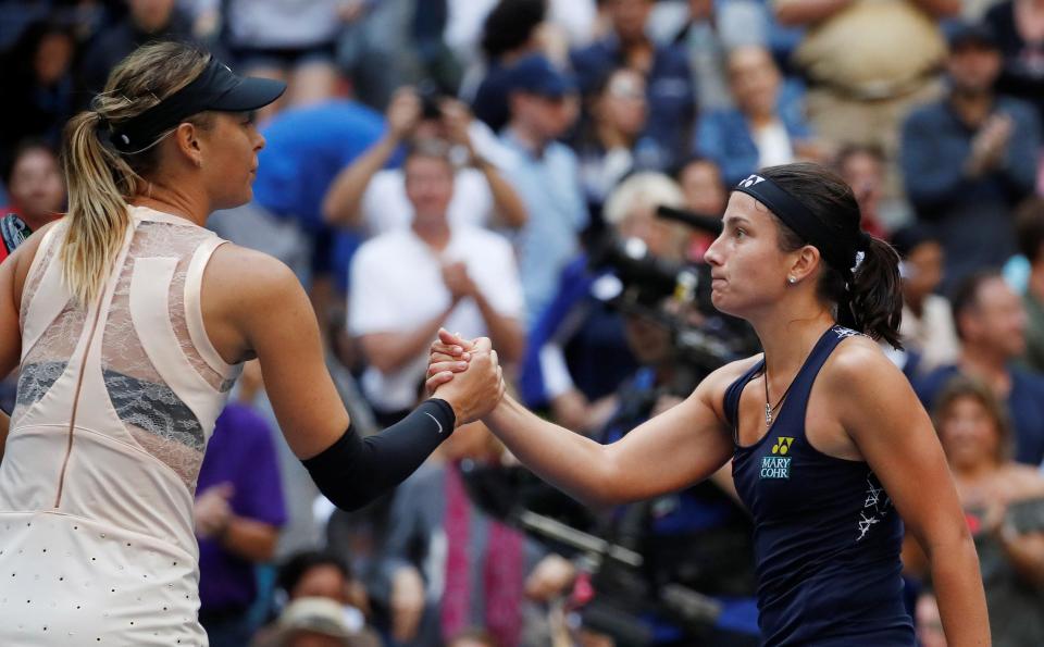  Maria Sharapova and Anastasija Sevastova embrace after their three-set epic at the US Open