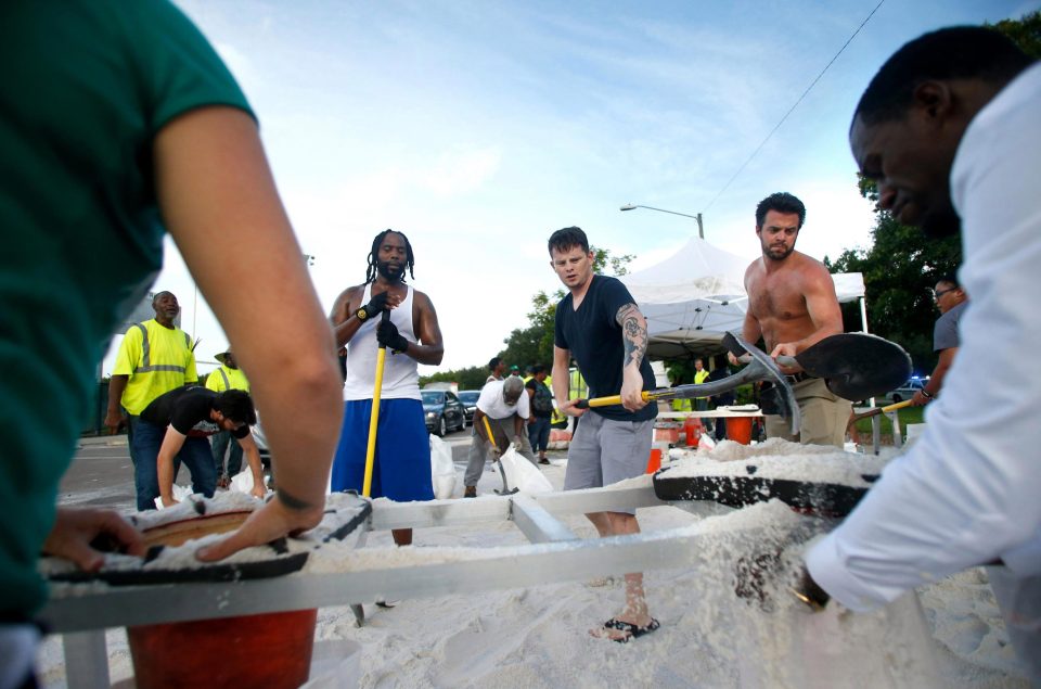  Residents work together to fill sandbags in preparation for the storm