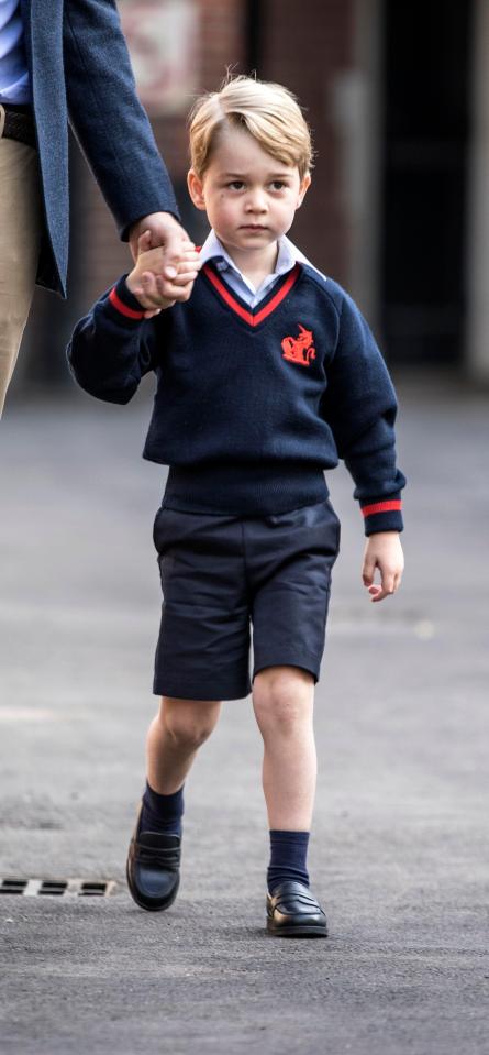  George looked nervous as he held onto his dad's hand as they walked into his new school