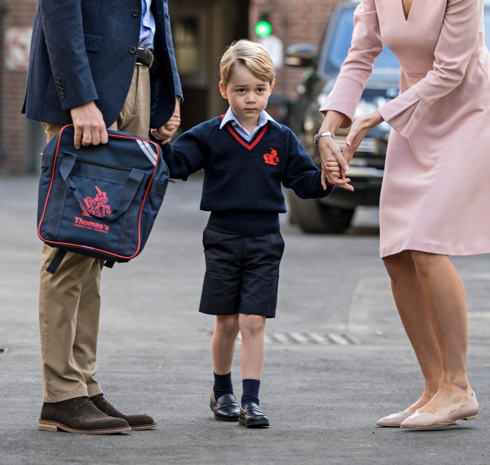  The young royal looked nervous as he was walked into school with his dad