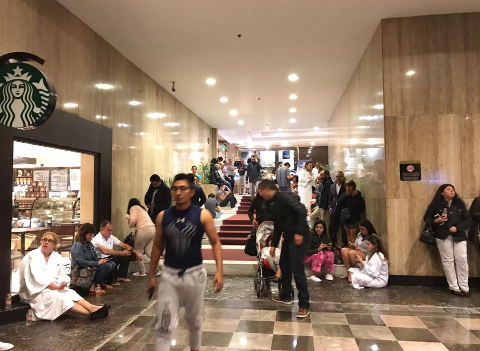  Tourists and residents were seen taking shelter after the powerful quake