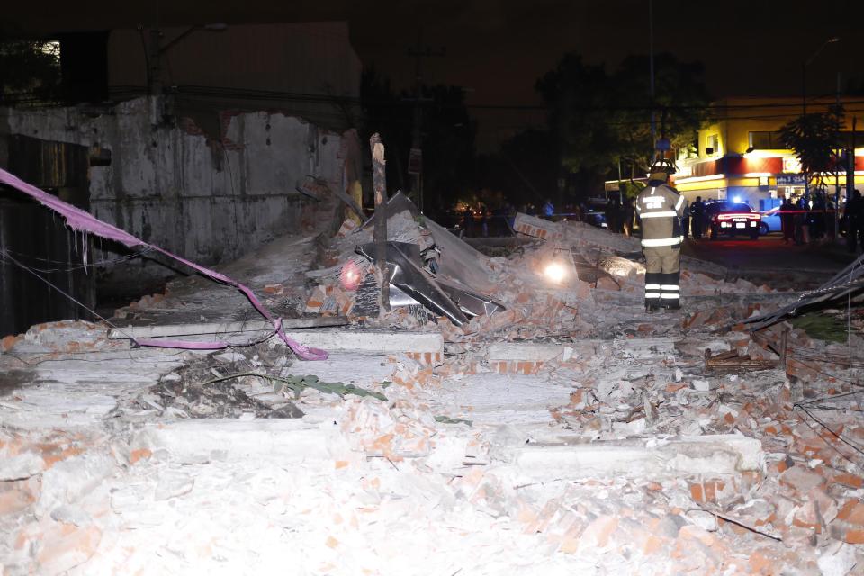  Emergency crews at the scene of a devastated building