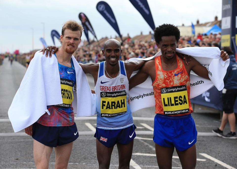  Great Britain's Mo Farah celebrates winning the men's elite with Jake Robertson (second) and Feyisa Lilesa (third)