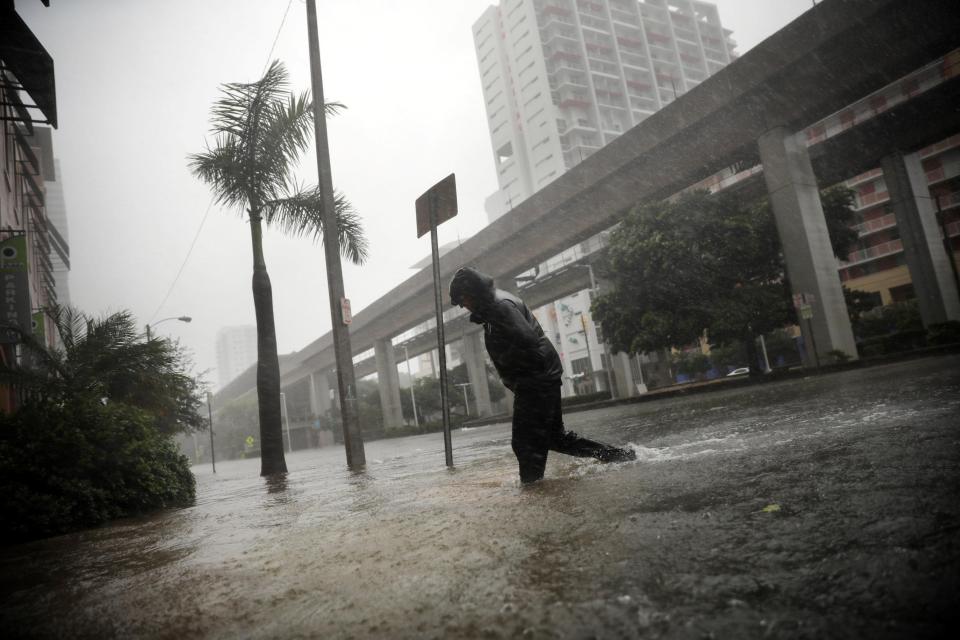  A man wades through knee-high water as the massive storm hit Florida