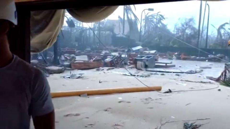  Debris and vegetation is seen scattered across the sand