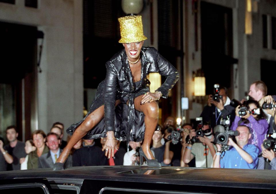  Former Bond girl Grace Jones donned a gold glitter hat as she arrived at the Philip Treacy show in 2000 - on the roof of her car