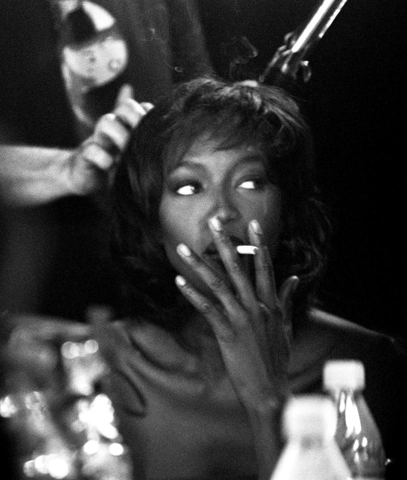  Naomi oozes Hollywood glamour while smoking backstage at the Matthew Williamson show in 1999 while having her hair and make-up done