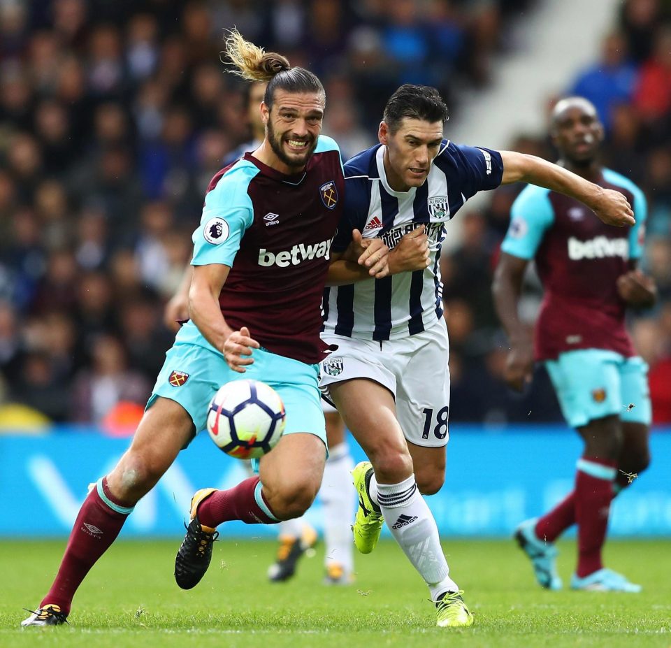 Former England team-mates Andy Carroll and Gareth Barry try to muscle each other off the ball