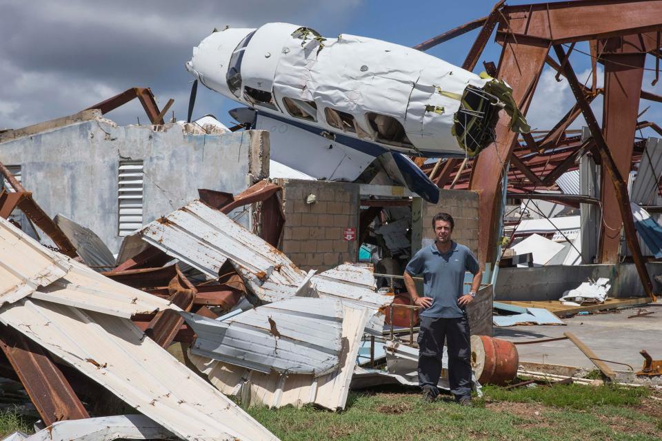  Sun reporter Nick Pisa in front of a wrecked hangar after Hurricane Irma