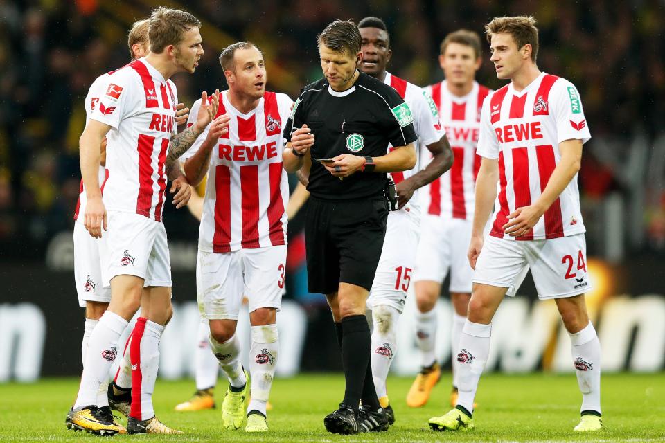  Cologne's Matthias Lehmann and his team-mates question with the official's decision