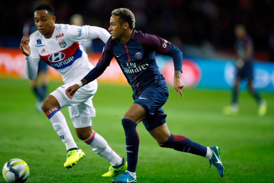  Neymar strides past Memphis Depay in the first-half