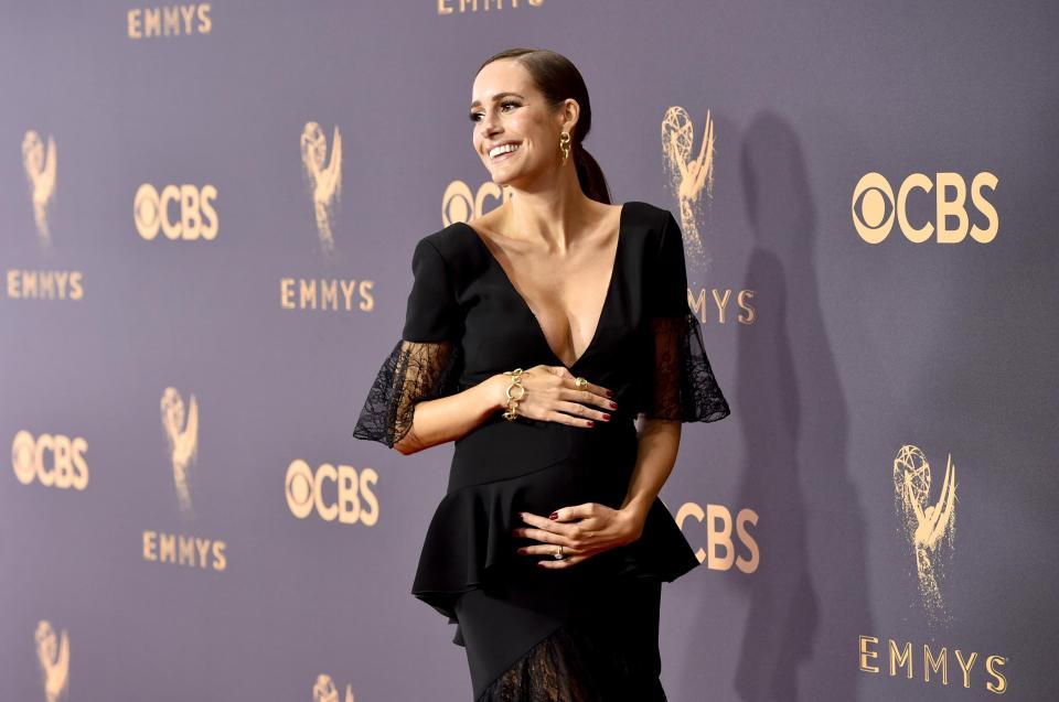  She cradled her baby bump as she posed for pictures