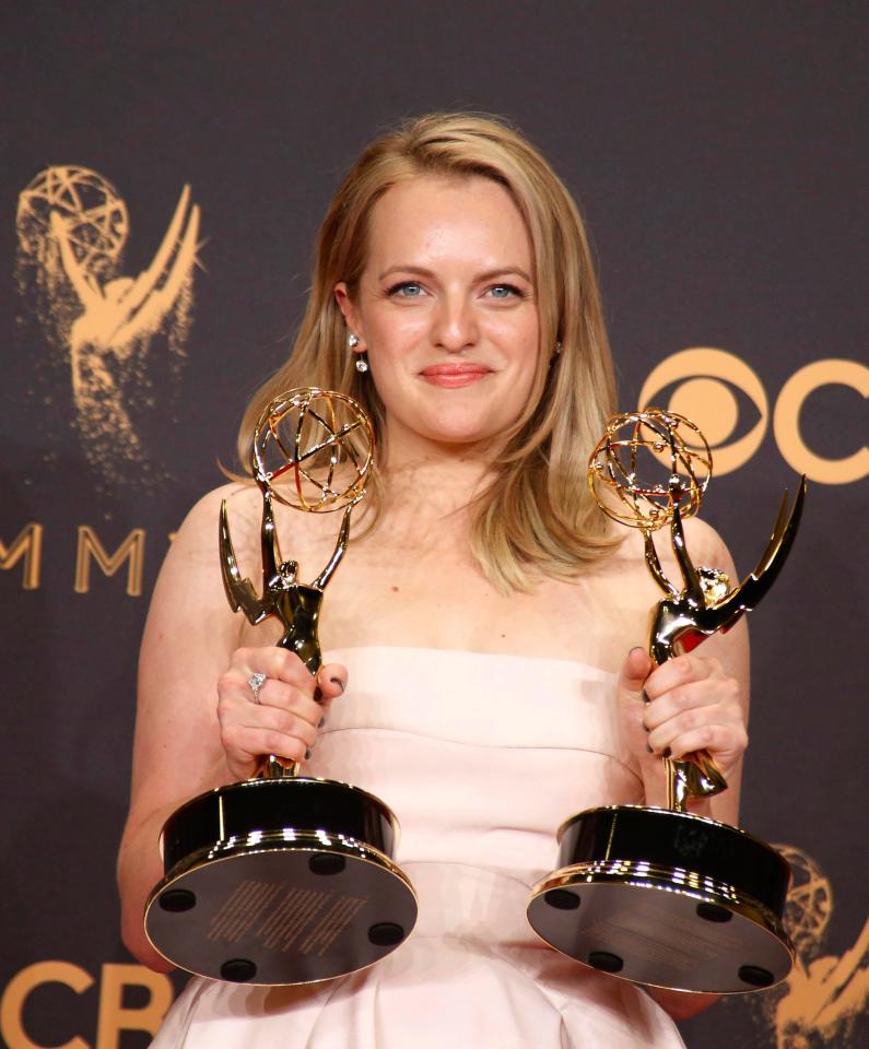  The US actress grinned as she held onto two of The Handmaid's Tales eight gongs