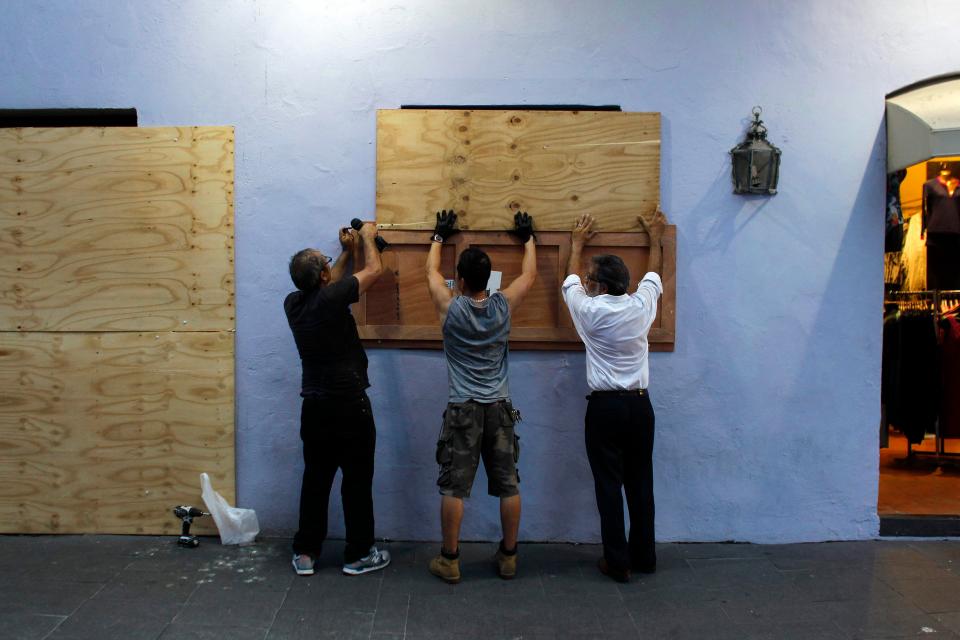  People board up windows of a business in preparation for Hurricane Maria in San Juan, Puerto Rico