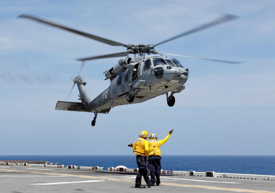  Crewmen direct a Navy MH-60S Sea Hawk departing the USS Kearsarge as American military continues to evacuate from the US Virgin Islands