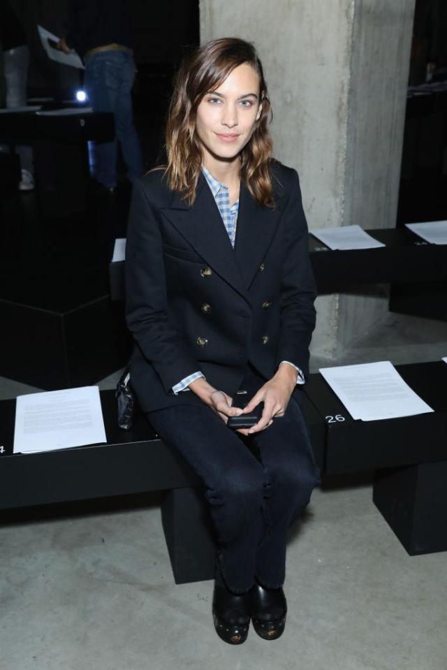  Model Alexa Chung poses on the front row ahead of the Christopher Kane show