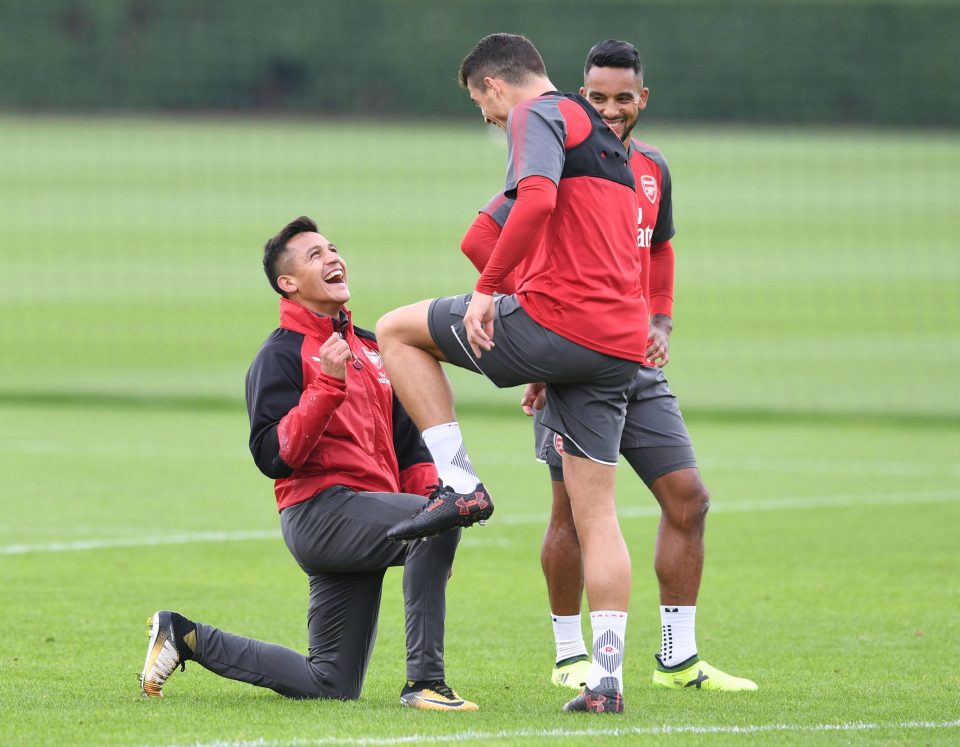  Sanchez pretended to polish Xhaka's boots as the two shared a giggle