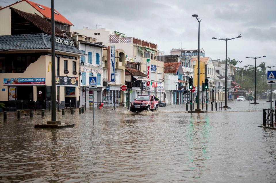  A motorist drives on the flooded waterfront in Fort-de-France, on the French Caribbean island of Martinique