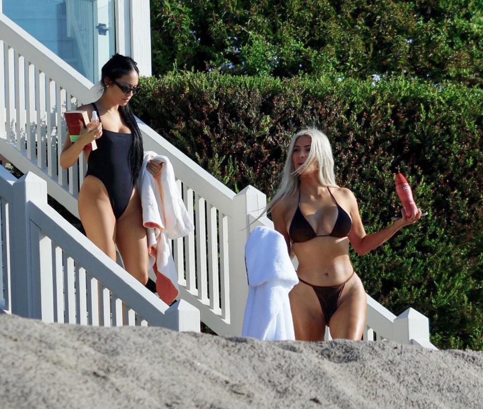  Kim and her friend hit the beach armed with cream and towels