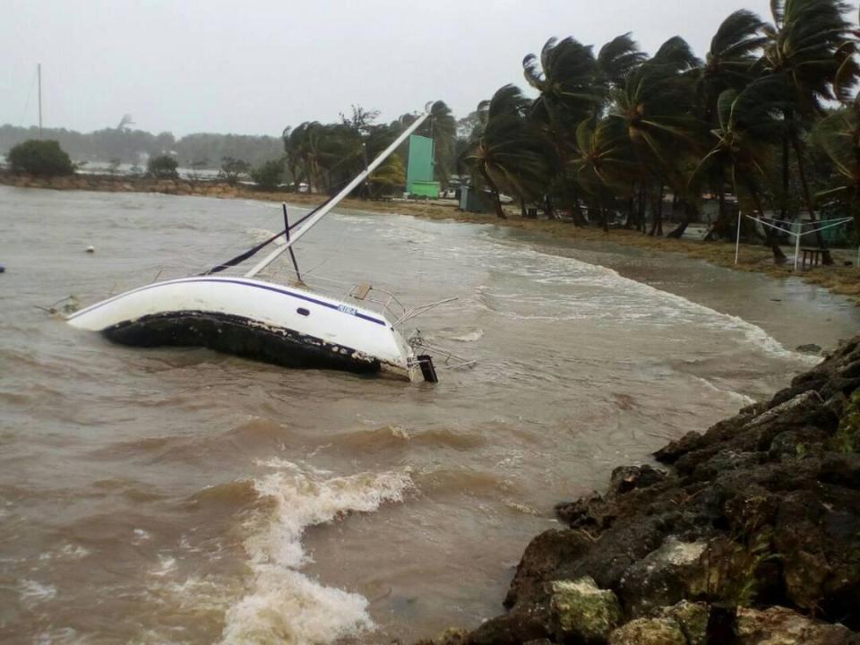  A boat lays on its side off the shore of Sainte-Anne on the French Caribbean island of Guadeloupe