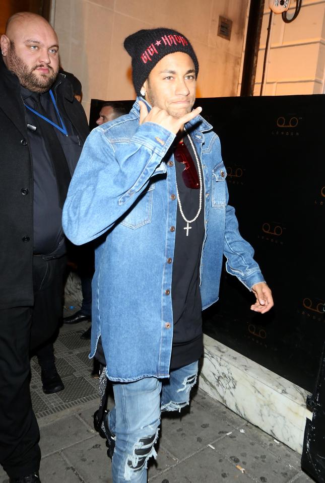 Neymar gestured as he walked down the street during his night out in London