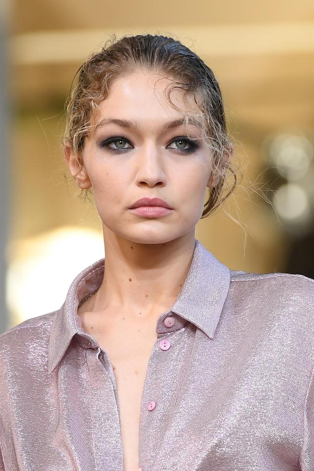  Gigi had heavy eye make-up and wet-look hair going on