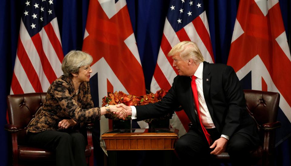  Theresa May attacked Donald Trump for threatening to pull out of major trade deals