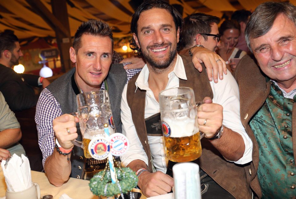 Germany legend Miroslav Klose and ex-Bayern Munich star Luca Toni enjoy a stein at Oktoberfest