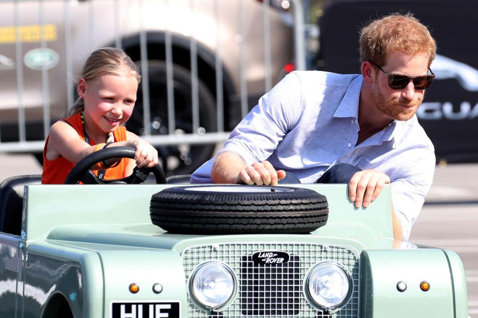  Former helicopter pilot Prince Harry zooms around with a young fan at the Invictus Games