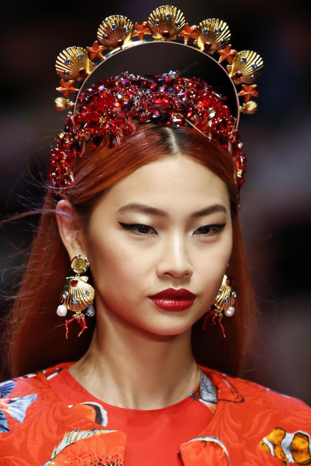  A model wears an elaborate, jewel-encrusted headpiece and dangling earrings in an under-the-sea inspired look