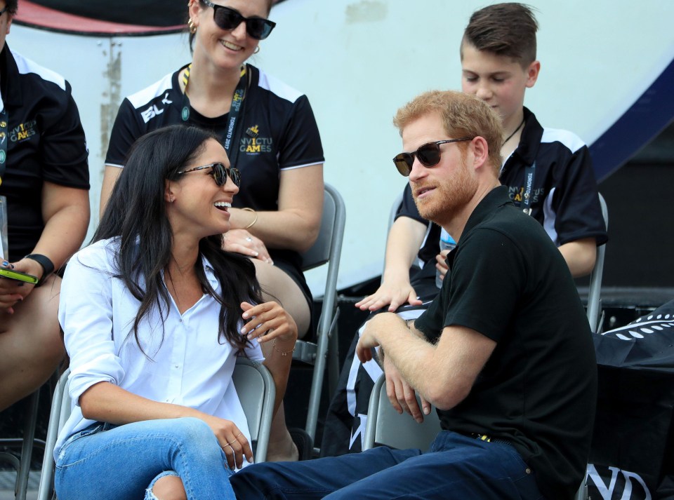 Meghan Markle laughs as she chats with her boyfriend