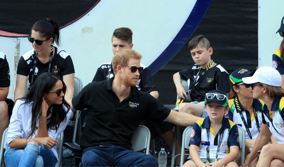 Prince Harry and Meghan chatted to fellow spectators during the match