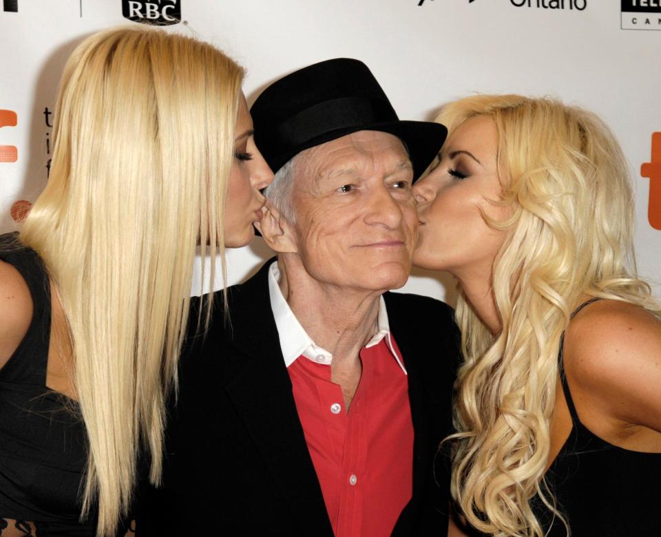 Hugh Hefner poses on the red carpet with girlfriends Karissa Shannon (left) and Crystal Harris in 2009