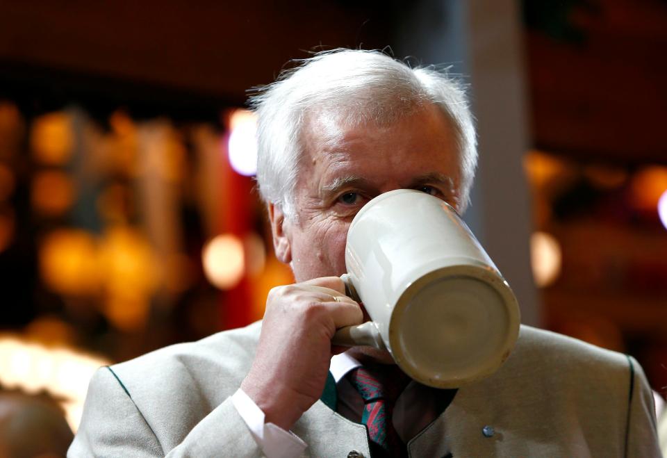  Bavarian state Premier Seehofer drinks beer from the first barrel during the Oktoberfest opening ceremony