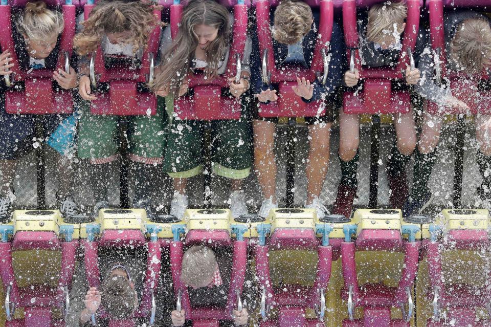  Young festival goers take a break from the beer and take a trip on one of the festivals fairground rides