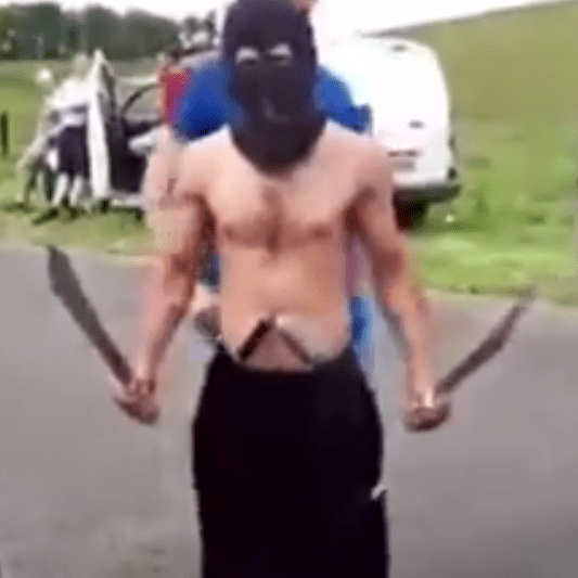  Raymond McIntyre is seen here wearing a balaclava and brandishing a number of blades