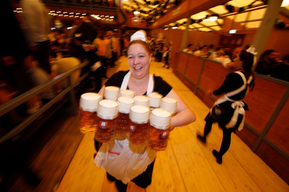  In an impressive feat, this waitress juggles huge steins of beer for revellers to enjoy